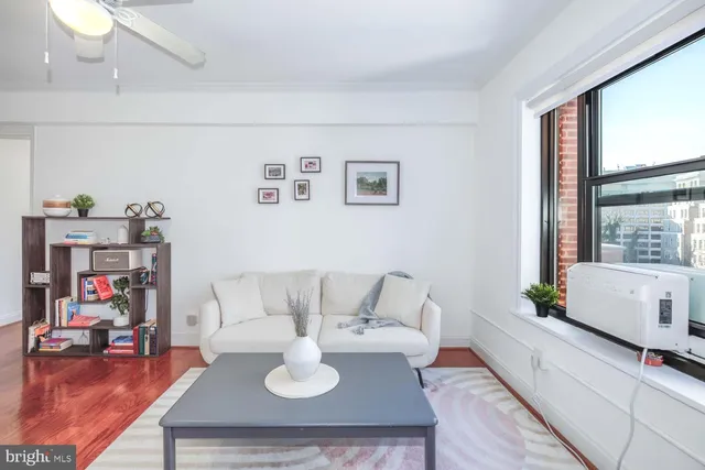 a living room with furniture a window and a chandelier