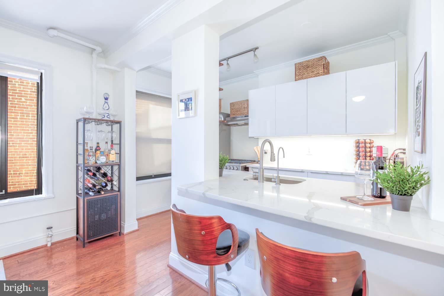 2100 19th Street Northwest, Unit 701 Washington, DC 20009 - Photo 6 of 24 a kitchen with stainless steel appliances granite countertop a refrigerator and a sink