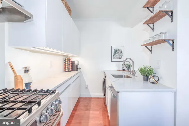 a bath room with a stove and a wooden floor