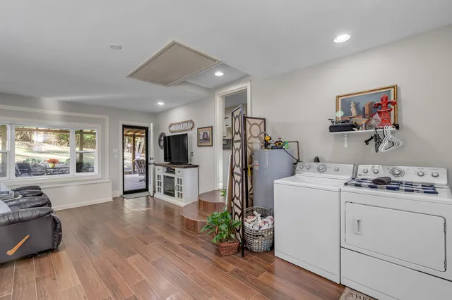 a view of a kitchen with fridge and wooden floor