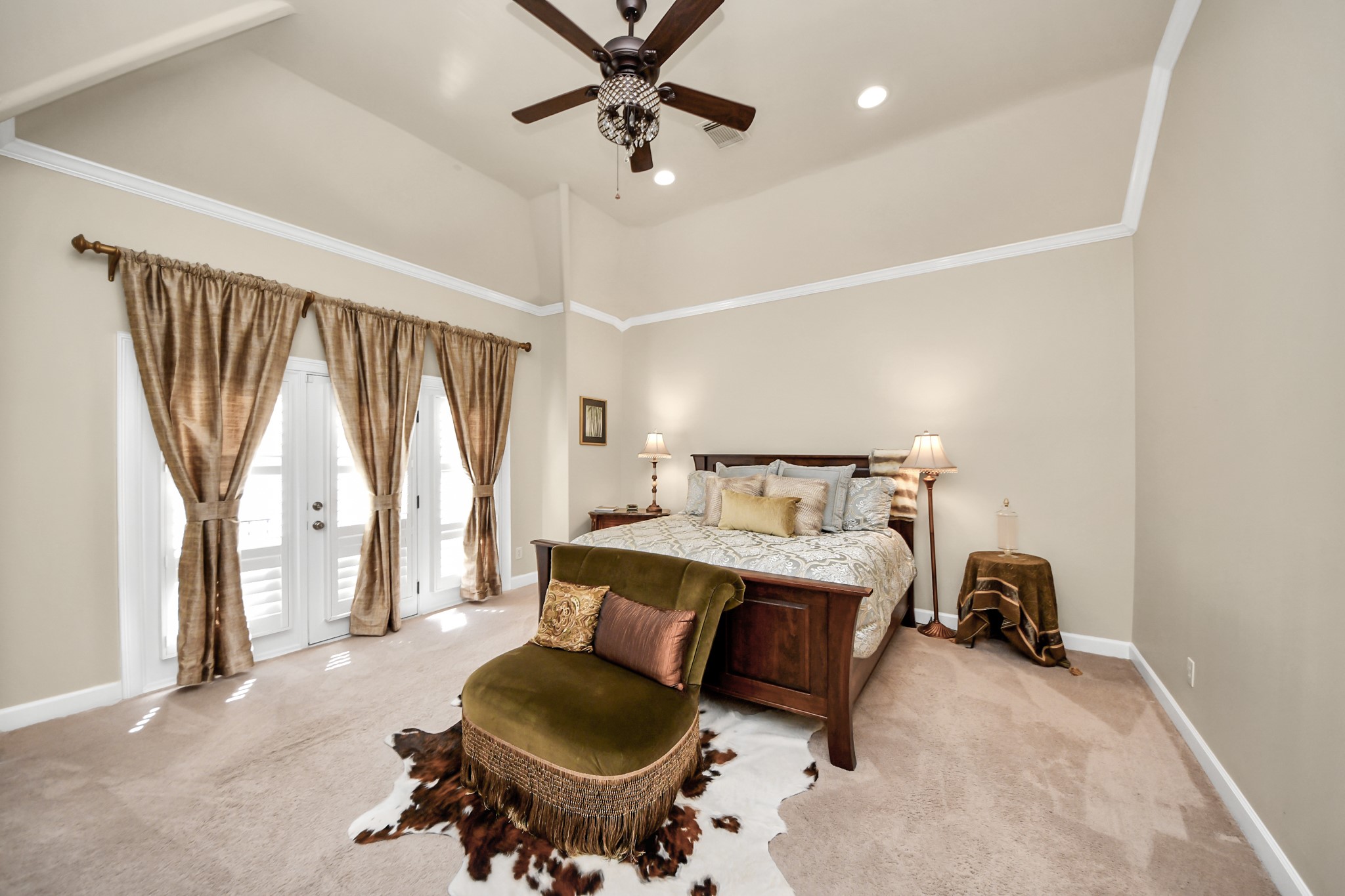 6302 Hermann Lake Drive Houston, TX 77021 - Photo 25 of 50 The spacious primary suite offers a peaceful retreat designed for comfort and relaxation. The large windows and French doors allow natural light to fill the room.