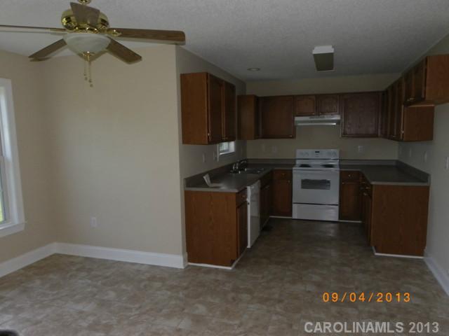 2210 Cedar Road York, SC 29745 - Photo 3 of 11 a kitchen with kitchen island a sink stainless steel appliances and cabinets