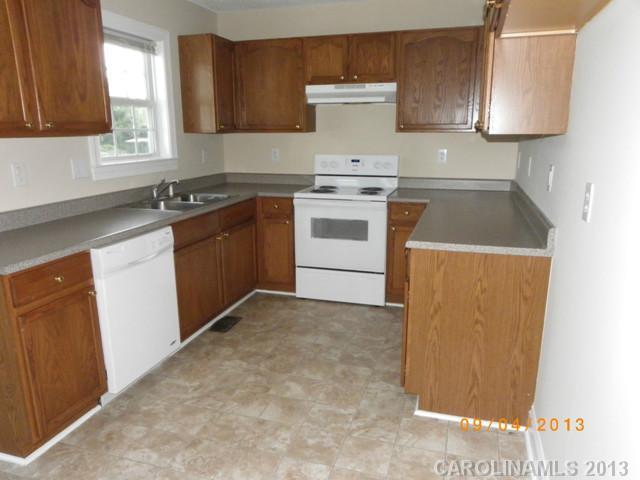 2210 Cedar Road York, SC 29745 - Photo 4 of 11 a kitchen with a sink a stove and cabinets