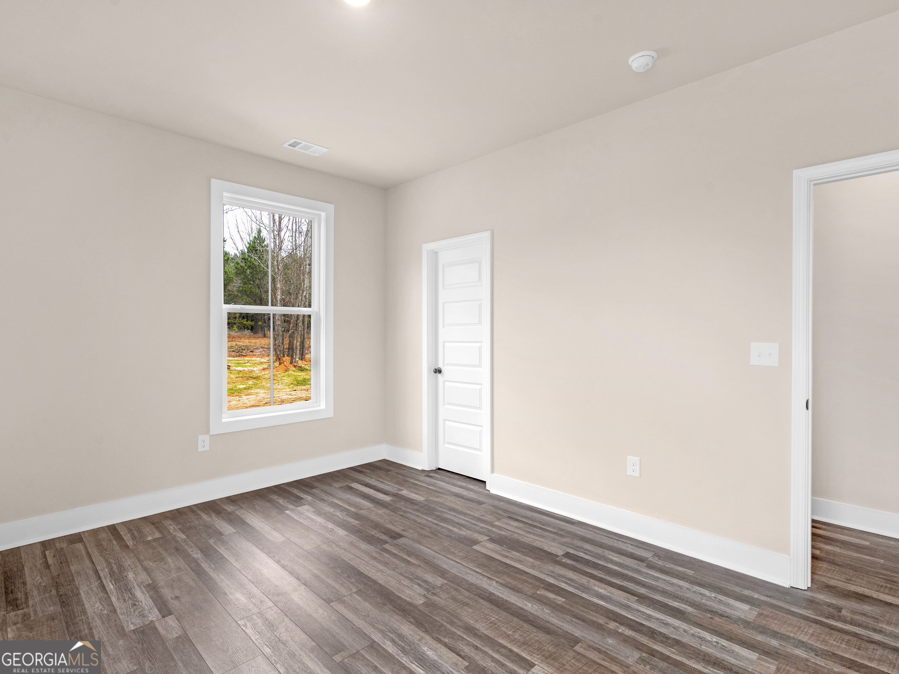 160 Loyd Road Mansfield, GA 30056 - Photo 35 of 53 an empty room with wooden floor and a window