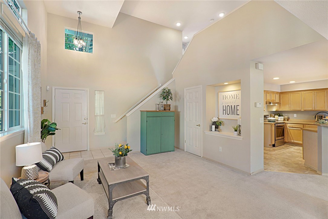 18469 Rainier View Road Southeast Monroe, WA 98272 - Photo 5 of 22 a living room with furniture and a kitchen