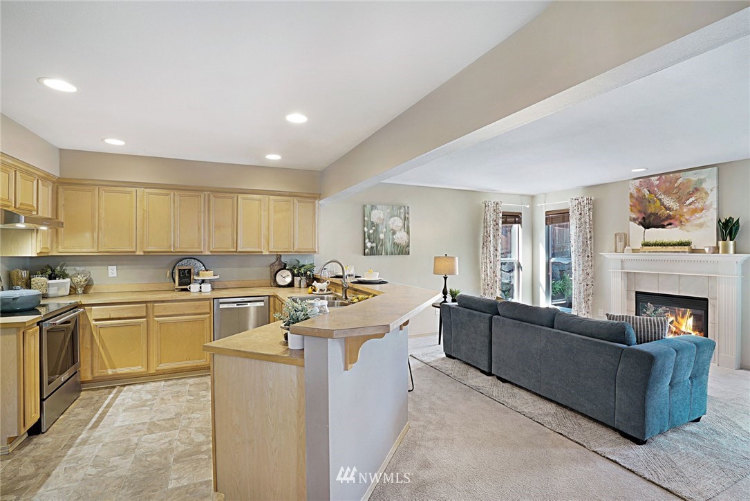 18469 Rainier View Road Southeast Monroe, WA 98272 - Photo 8 of 22 a open kitchen with cabinets a stove and a sink