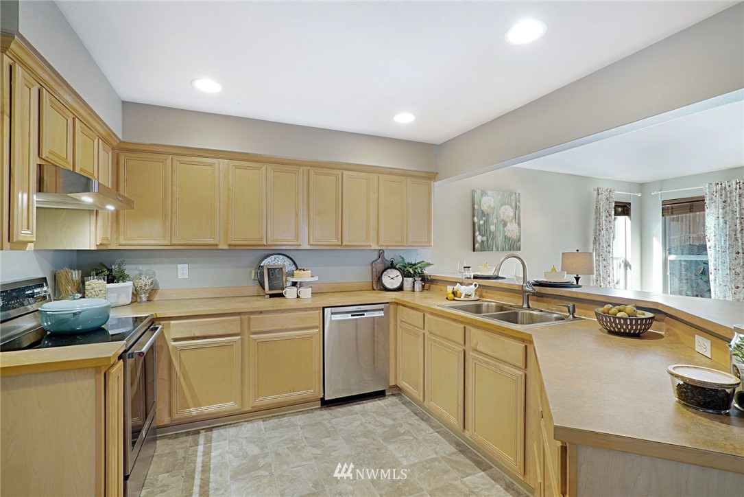 18469 Rainier View Road Southeast Monroe, WA 98272 - Photo 10 of 22 a kitchen with a sink stove and cabinets
