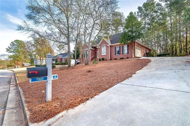 a front view of a building with trees