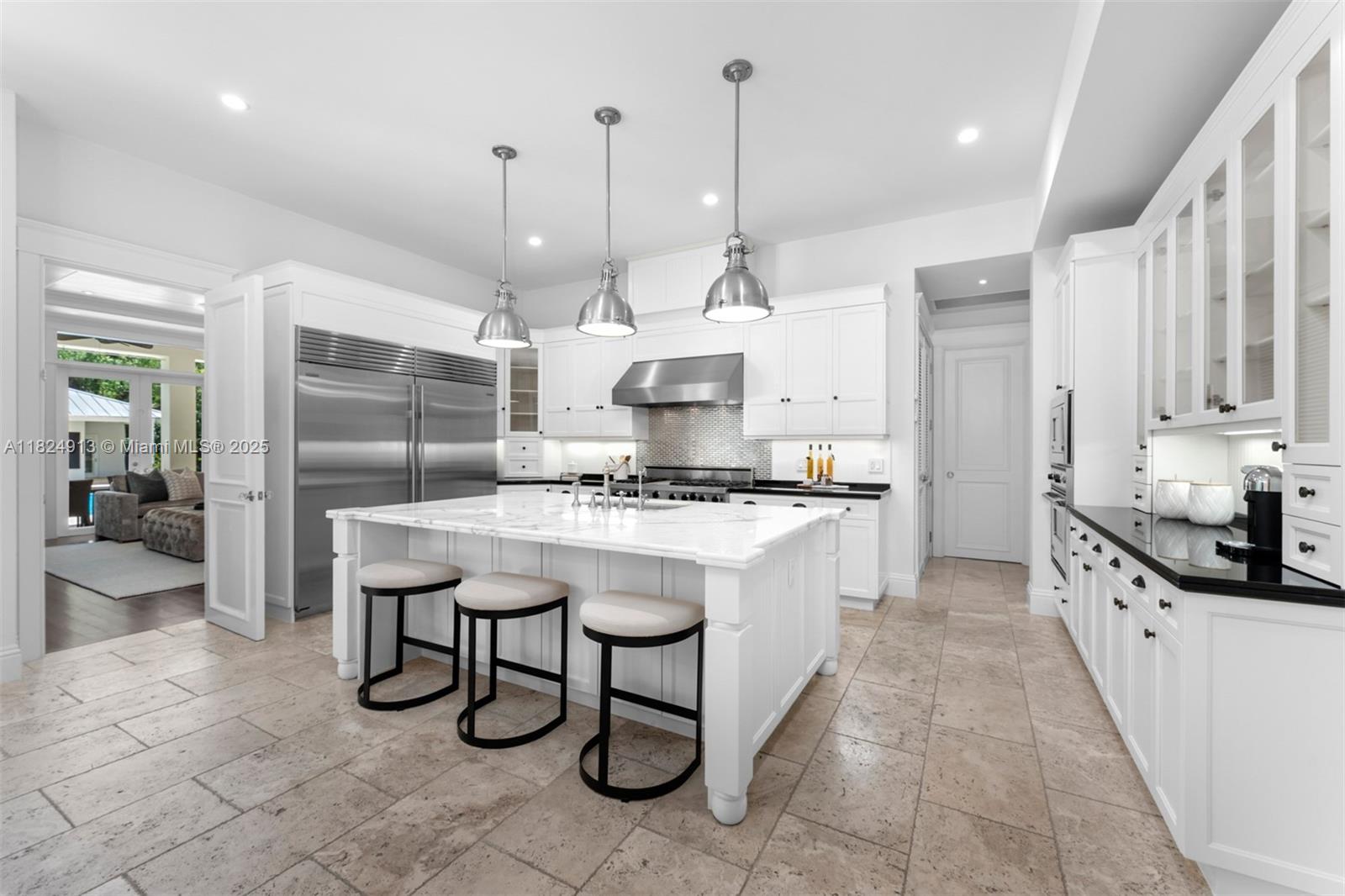 7415 Southwest 49th Place Miami, FL 33143 - Photo 17 of 60 a kitchen with stainless steel appliances kitchen island granite countertop a sink a counter space and cabinets