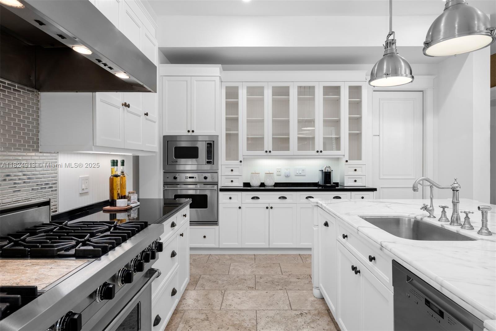 7415 Southwest 49th Place Miami, FL 33143 - Photo 18 of 60 a kitchen with stainless steel appliances a stove a sink and a refrigerator