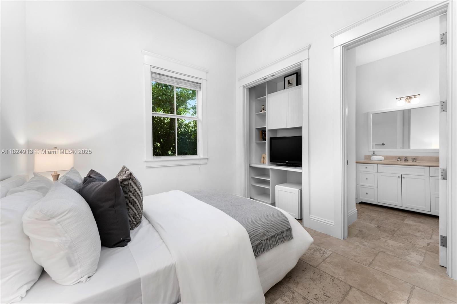 7415 Southwest 49th Place Miami, FL 33143 - Photo 22 of 60 a bedroom with a bed and a flat screen tv
