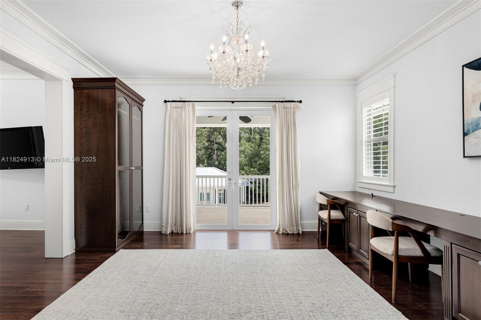 7415 Southwest 49th Place Miami, FL 33143 - Photo 25 of 60 a bedroom with a bed and a chandelier