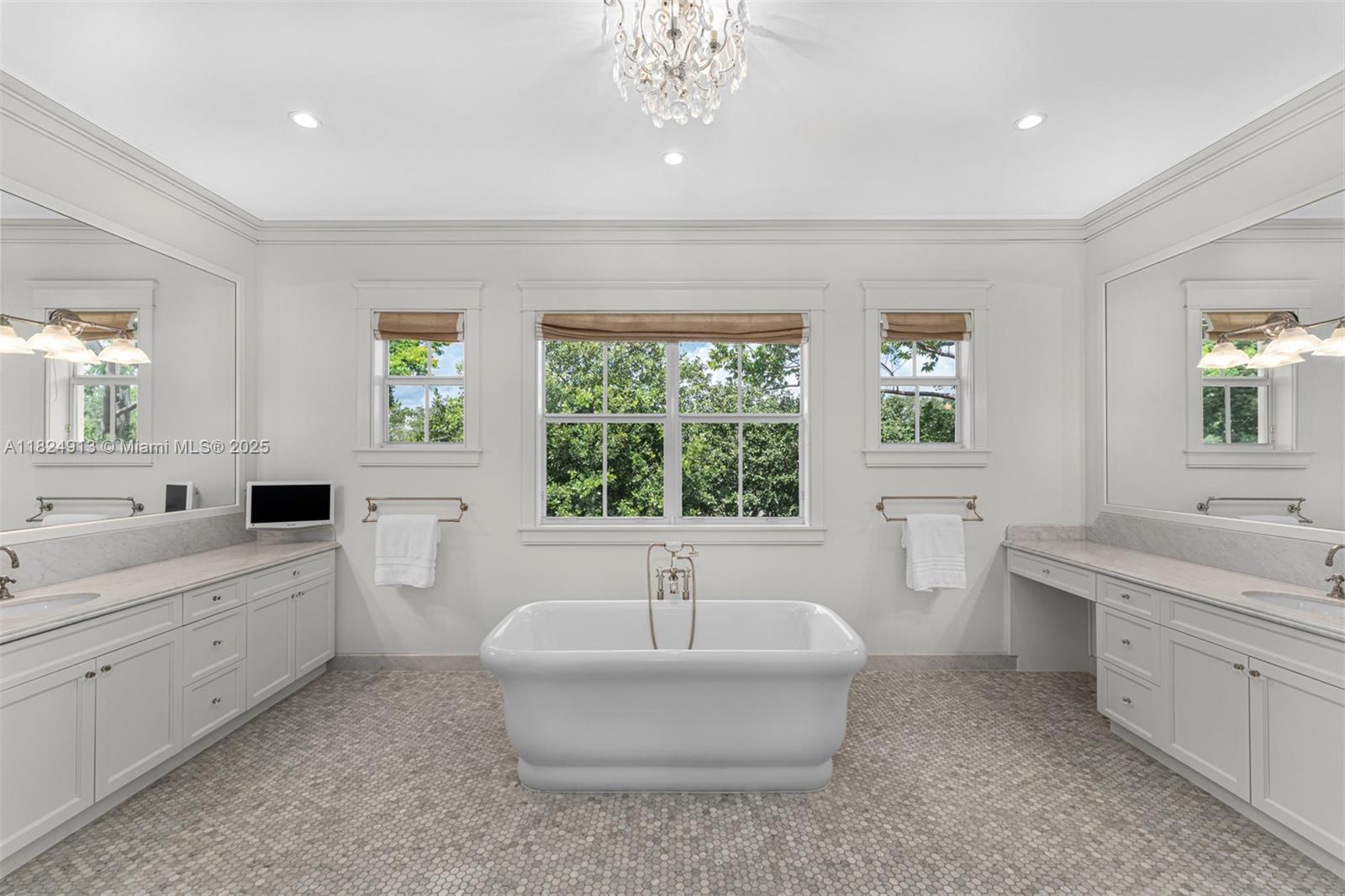7415 Southwest 49th Place Miami, FL 33143 - Photo 29 of 60 a spacious bathroom with double vanity a window a bathtub and a window
