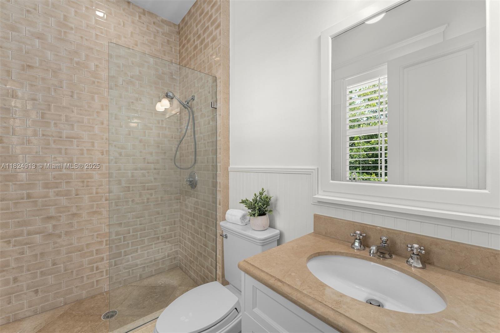 7415 Southwest 49th Place Miami, FL 33143 - Photo 34 of 60 a bathroom with a granite countertop sink toilet a mirror and shower
