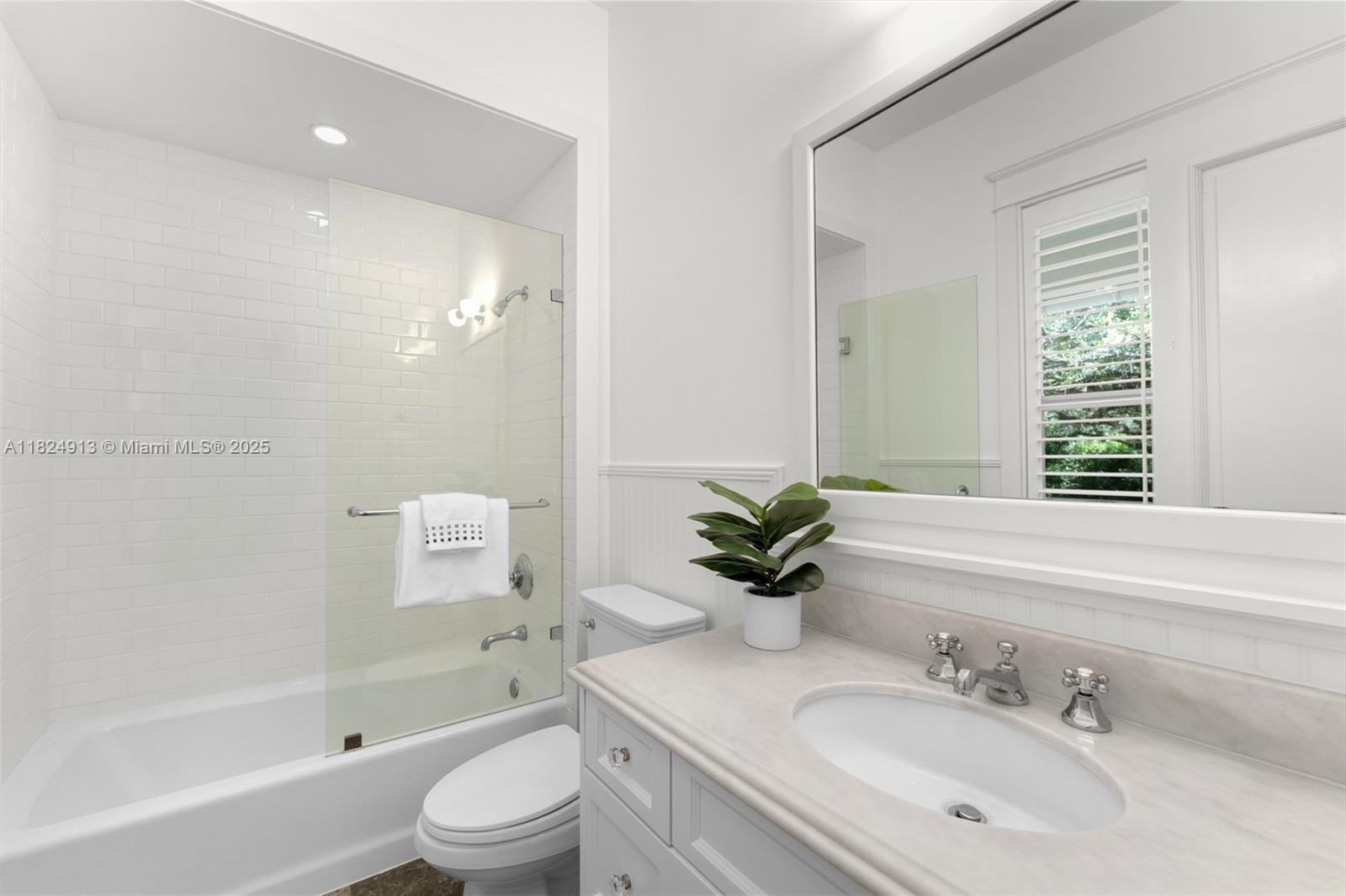 7415 Southwest 49th Place Miami, FL 33143 - Photo 36 of 60 a bathroom with a granite countertop sink toilet a large mirror a shower and a bathtub