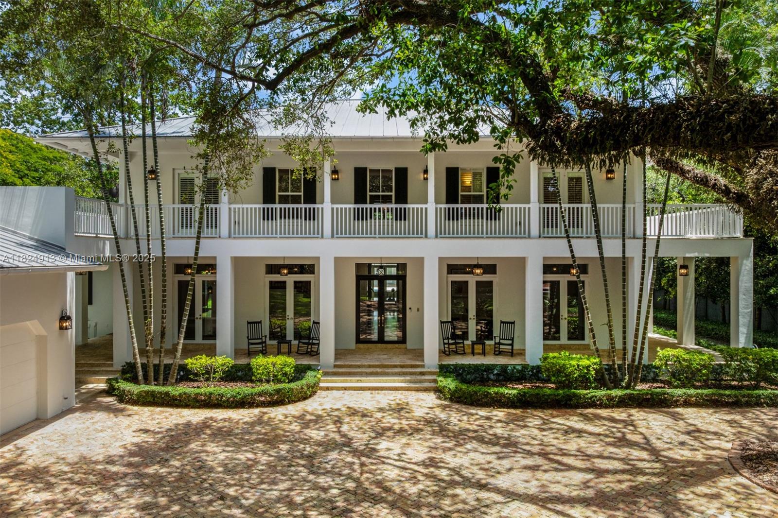 7415 Southwest 49th Place Miami, FL 33143 - Photo 48 of 60 a view of a white house with large windows and a large tree