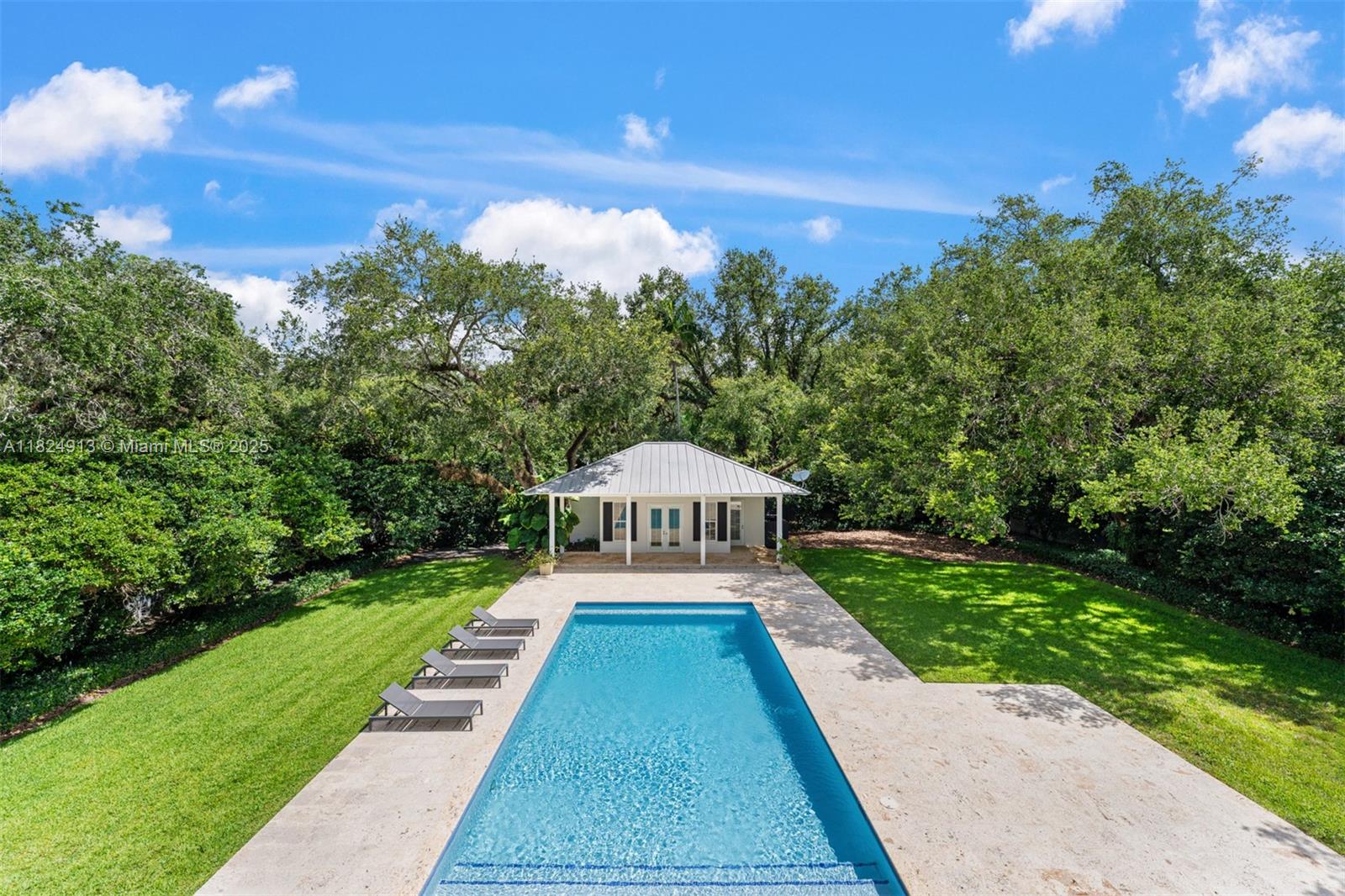 7415 Southwest 49th Place Miami, FL 33143 - Photo 50 of 60 a view of swimming pool in front of house with green yard