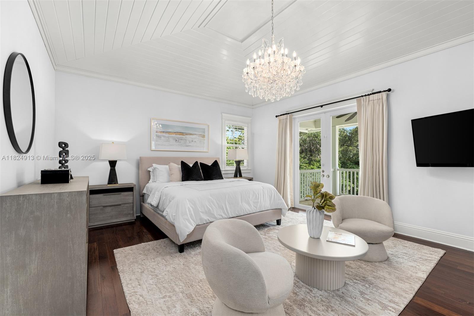 7415 Southwest 49th Place Miami, FL 33143 - Photo 5 of 60 a spacious bedroom with a bed and a chandelier