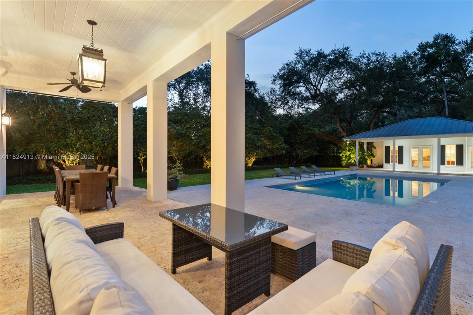 7415 Southwest 49th Place Miami, FL 33143 - Photo 59 of 60 a outdoor space with patio the couches and a dining table with garden view