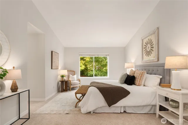 a bedroom with a bed and lamp next to a window