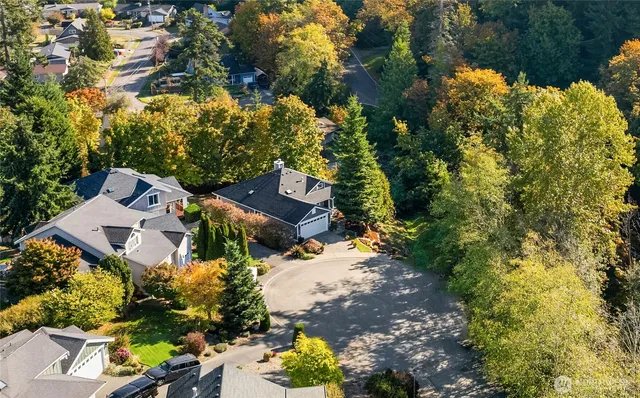 an aerial view of a house with a yard and swimming pool
