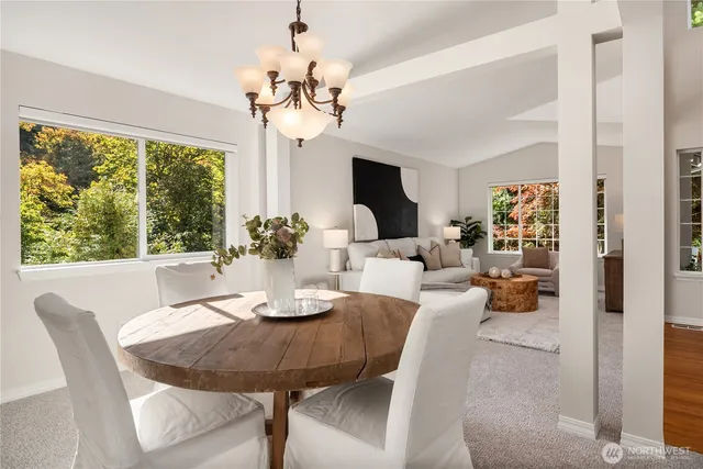 a view of a dining room with furniture wooden floor and chandelier