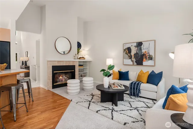 a living room with furniture a fireplace and a table