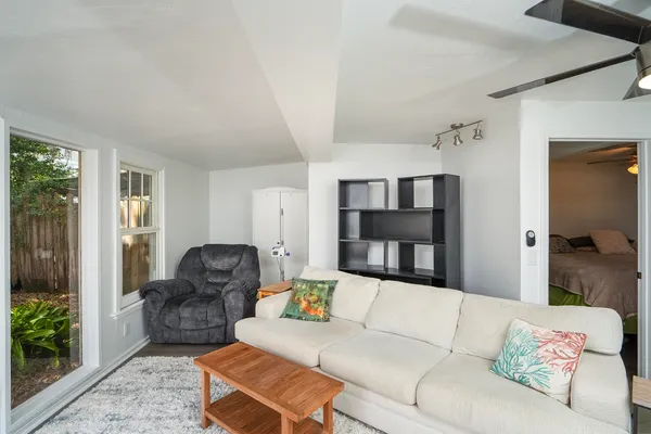 a living room with furniture and a wooden floor