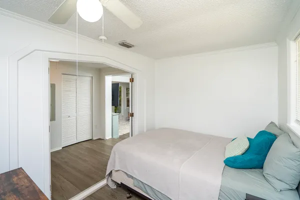 a bedroom with a bed and a large window