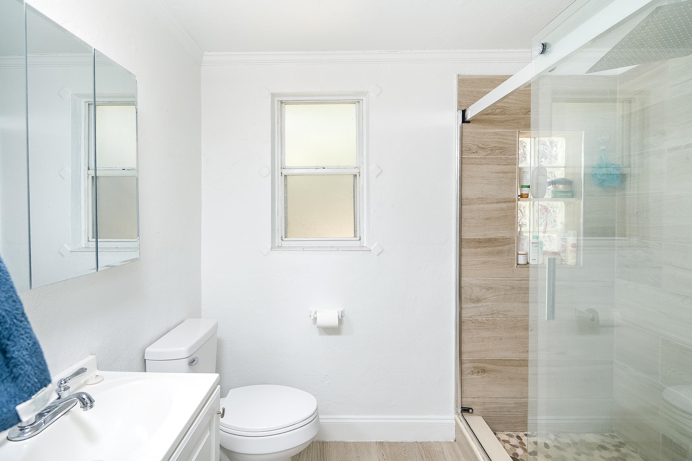 490 Pyrus Street St. Augustine, FL 32080 - Photo 18 of 35 a white toilet sitting next to a bathroom sink