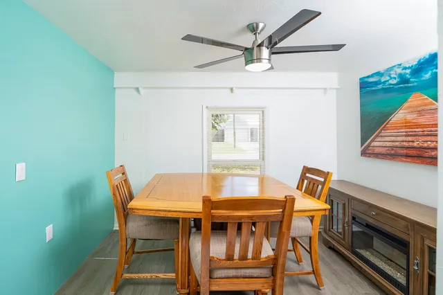 a bed room with a bed and a ceiling fan