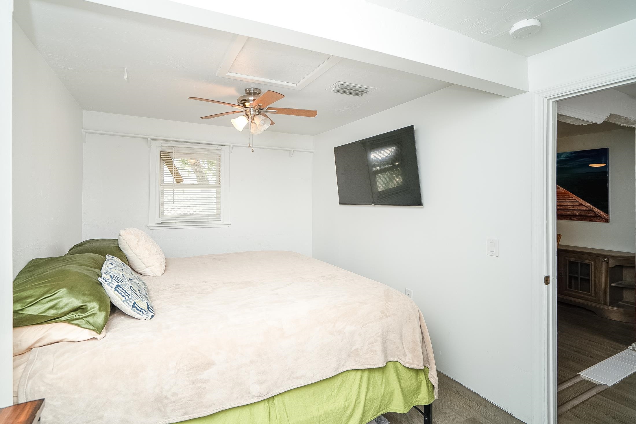 490 Pyrus Street St. Augustine, FL 32080 - Photo 23 of 35 a bedroom with a bed and a chandelier