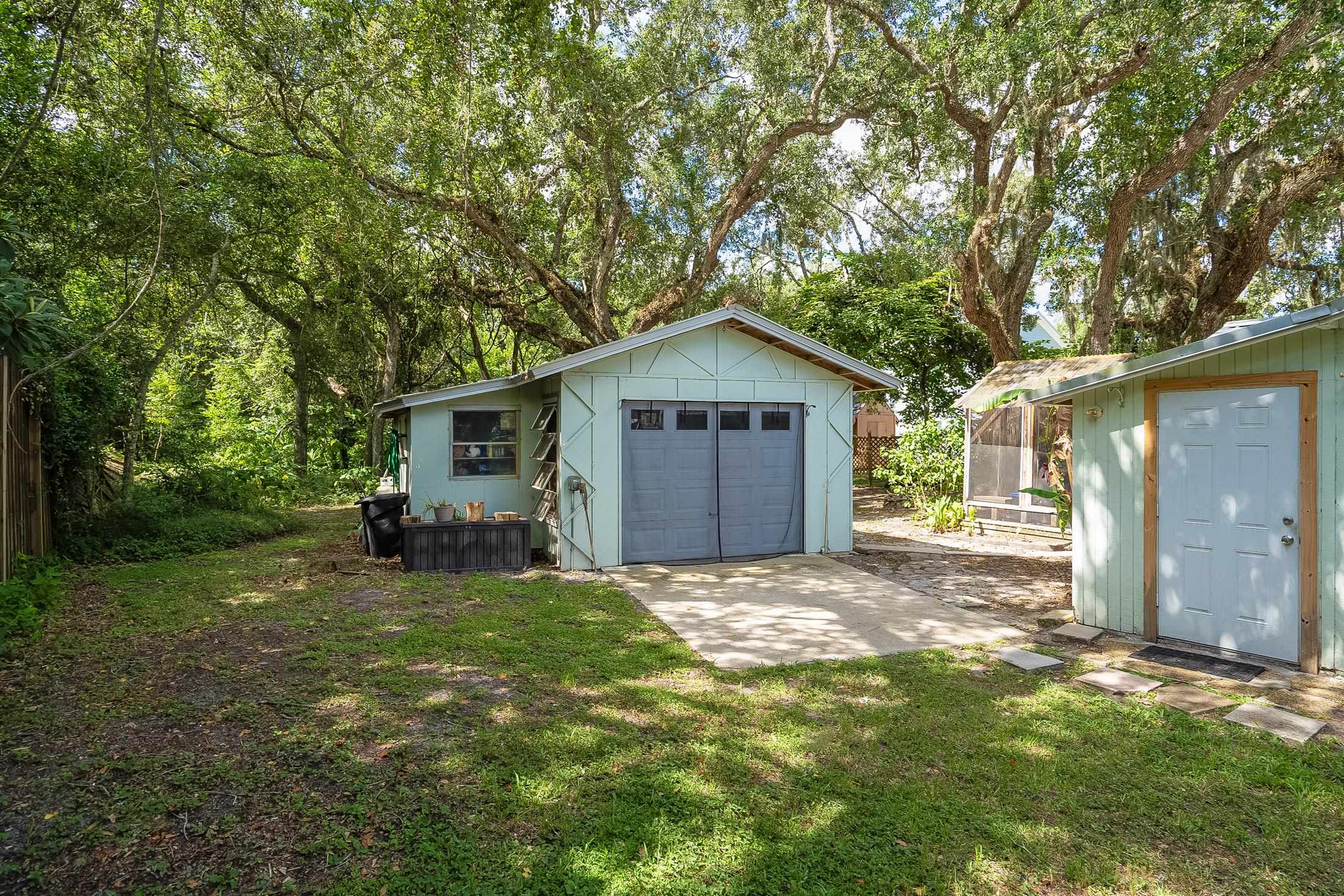 490 Pyrus Street St. Augustine, FL 32080 - Photo 30 of 35 a view of a house with a yard and large tree