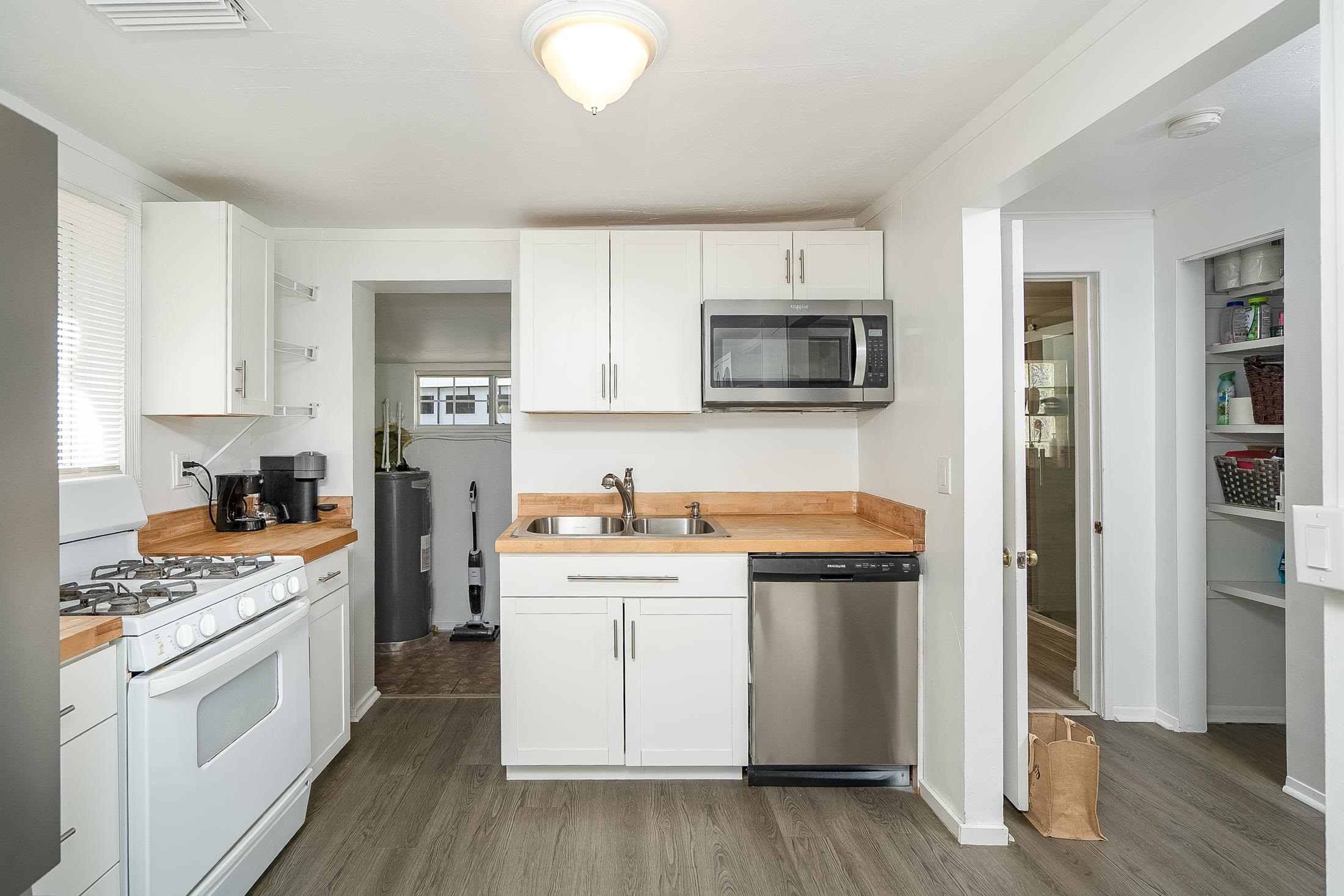 490 Pyrus Street St. Augustine, FL 32080 - Photo 8 of 35 a kitchen with stainless steel appliances a stove microwave and cabinets