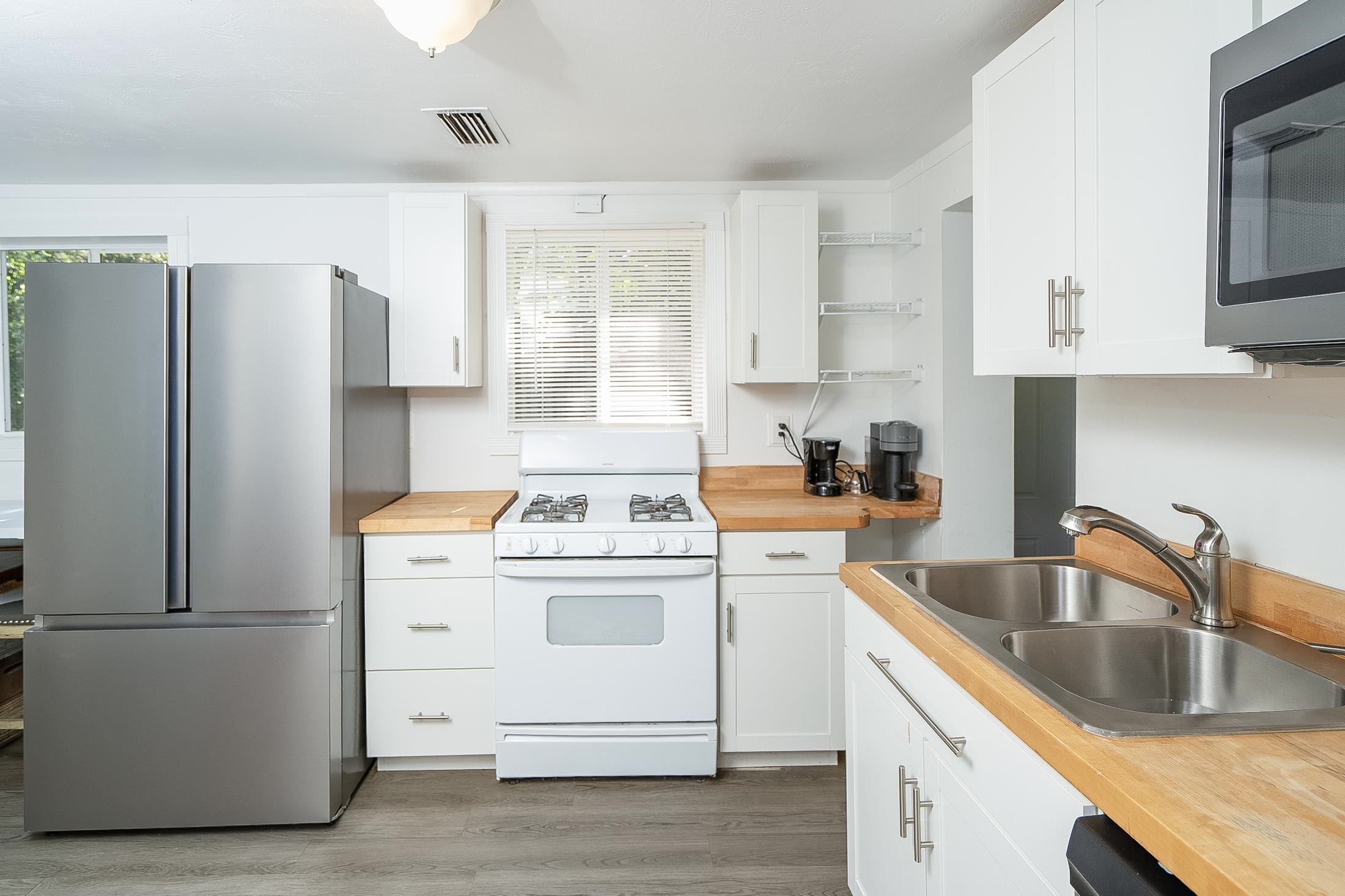 490 Pyrus Street St. Augustine, FL 32080 - Photo 9 of 35 a kitchen with a stove sink and refrigerator