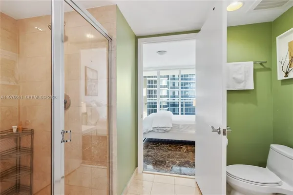 a bathroom with a toilet sink and shower