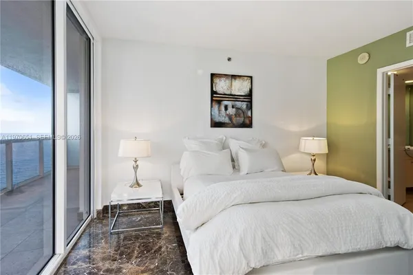 a bedroom with a bed and a painting on the wall