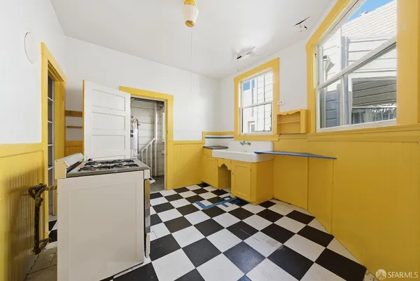 a kitchen with a stove a sink and a refrigerator