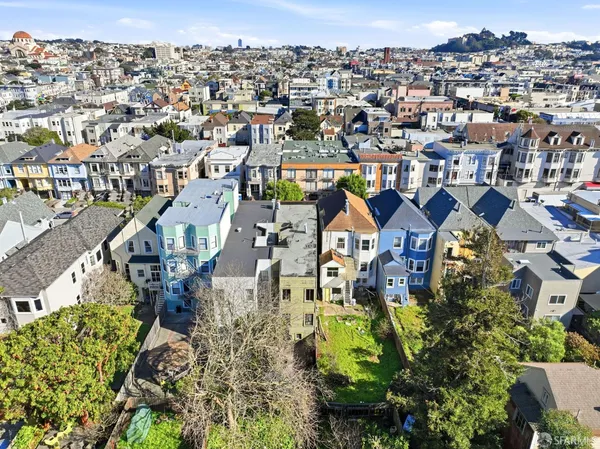 an aerial view of a residential apartment building with a yard