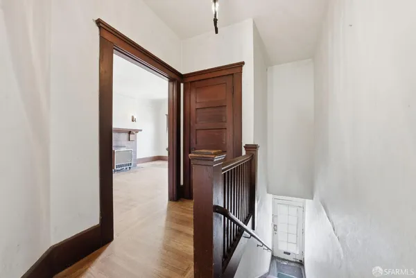 a view of hallway with wooden floor