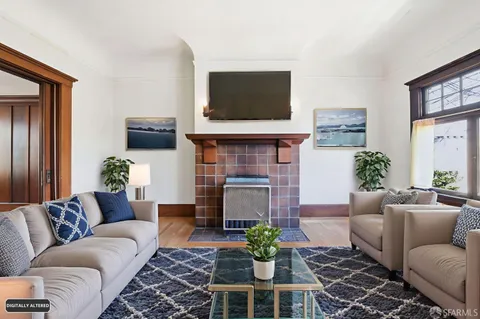 a living room with furniture a flat screen tv and a fireplace