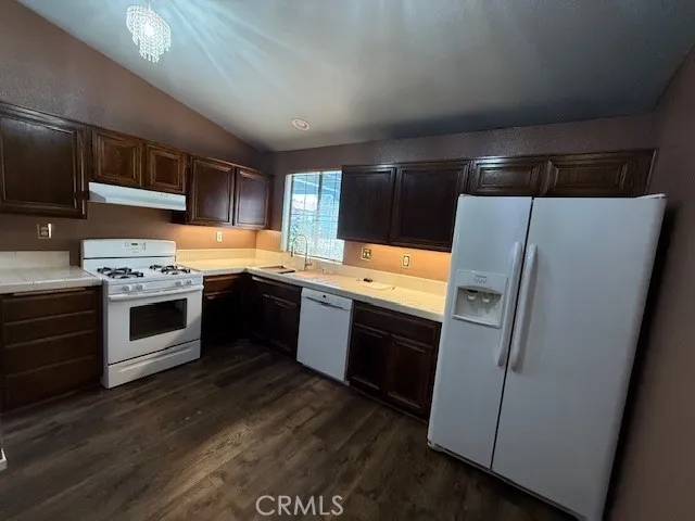 a kitchen with stainless steel appliances a stove a sink and a refrigerator