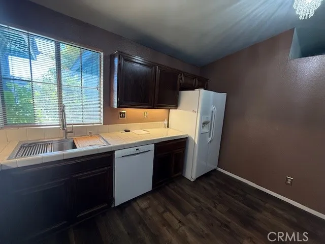 a room with a sink cabinets and wooden floor