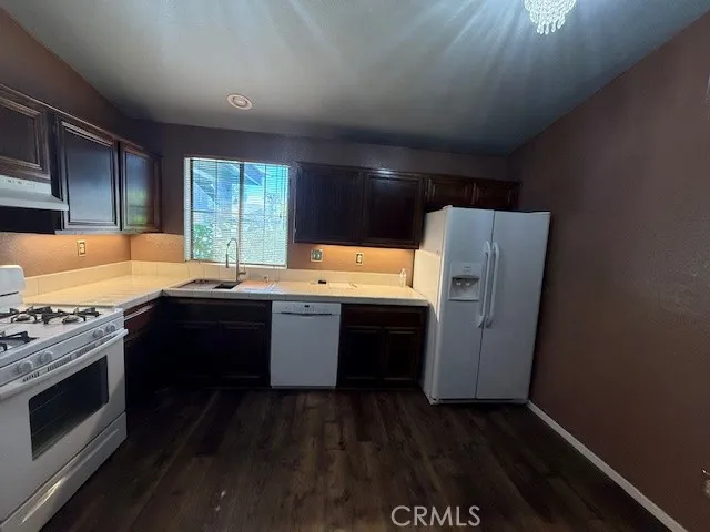 a kitchen with a refrigerator and a sink
