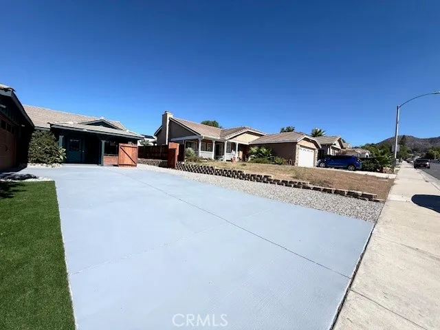 a view of a house with a yard and sitting area