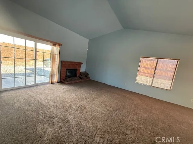 an empty room with furniture and a fireplace