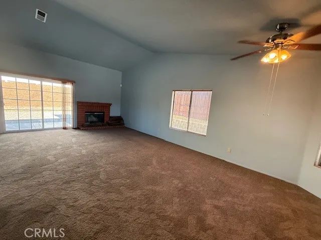 a view of a livingroom with a ceiling fan and window