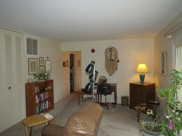 a living room with furniture and a lamp