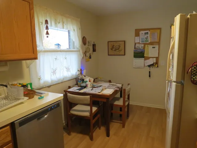 a view of a kitchen with a table and chairs