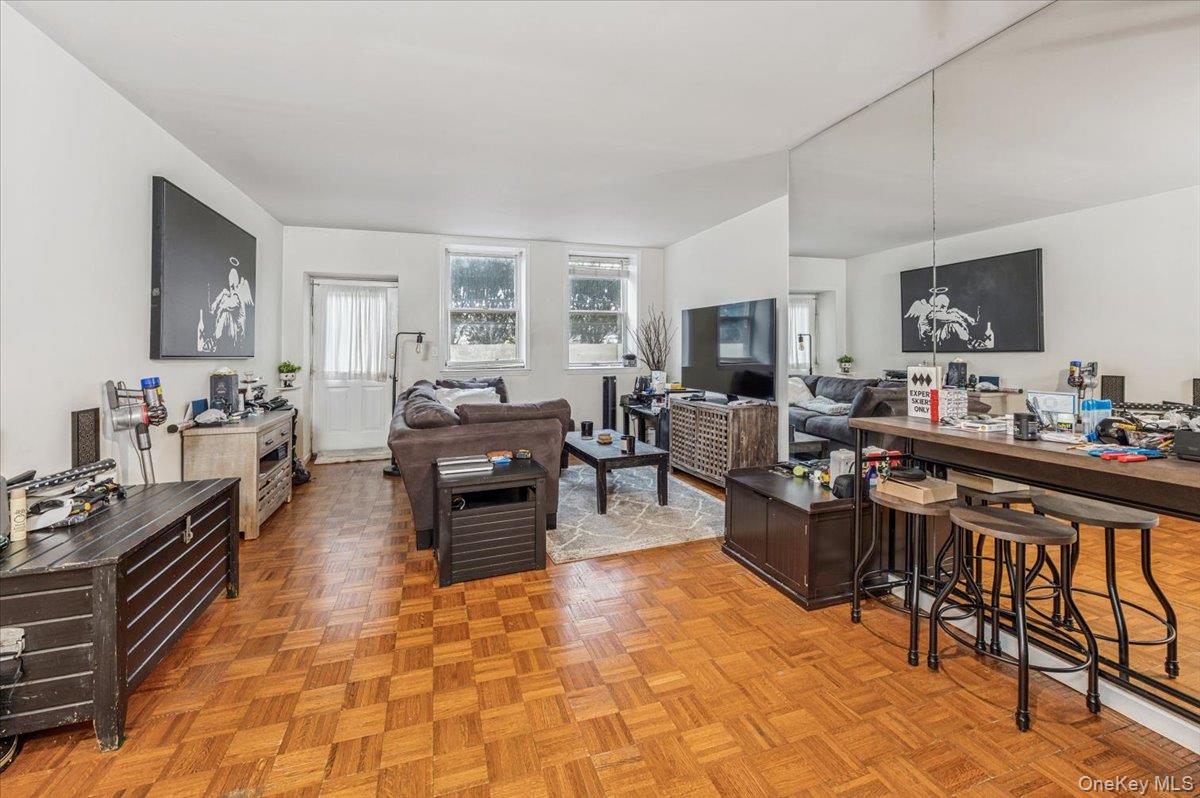 1250 North Avenue, Unit 115 New Rochelle, NY 10804 - Photo 2 of 16 a living room with fireplace furniture and a flat screen tv